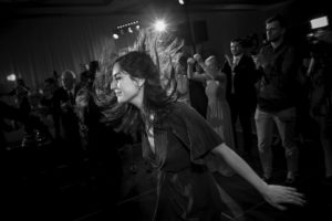 Black and white photo of a woman dancing at a wedding at the Alfond Inn.