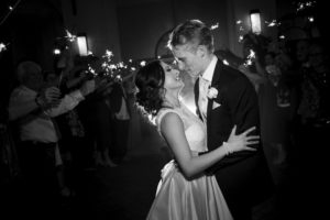 A bride and groom sharing their first dance at a wedding with sparklers at the Alfond Inn.