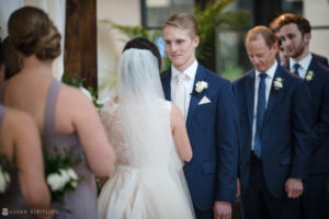 A bride and groom look at each other during their Alfond Inn wedding ceremony.