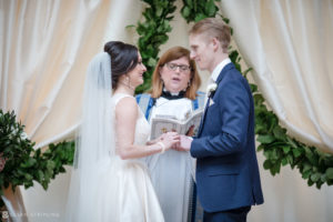 A bride and groom exchange vows at the Alfond Inn during their wedding ceremony.