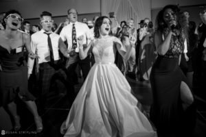 A bride and groom dancing on the dance floor at a wedding at the Alfond Inn.