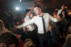 A man is dancing at a wedding reception on the dance floor at Alfond Inn.