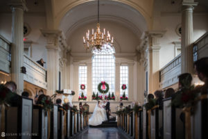 A Winter Wedding bride and groom standing in the aisle of Front and Palmer church.