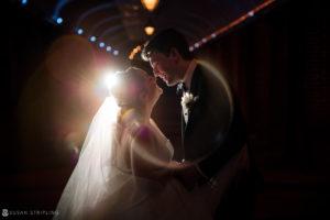 A Winter wedding in a tunnel at Front and Palmer, with sunlight shining on the bride and groom.