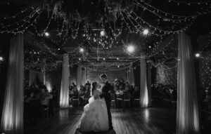 A winter wedding bride and groom's first dance under string lights at Front and Palmer.