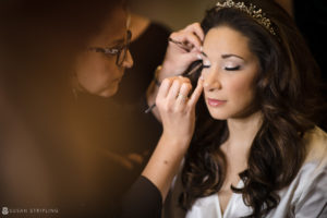 A bride getting her makeup done before her wedding at Philly's Union League.