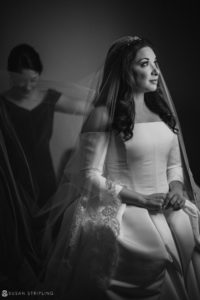 A bride is getting ready for her wedding at Philly's Union League, a dark room set with an air of anticipation.