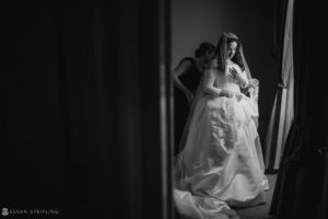 A bride is getting ready for her wedding at Philly's Union League in a black and white photo.