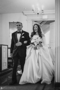 A wedding at Philly's Union League, with the bride walking down the aisle accompanied by her father.