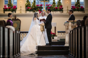 A wedding couple exchange vows in Philly's Union League, a beautiful church venue.