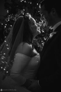 A black and white photo of a bride and groom in front of a Philadelphia's Union League.