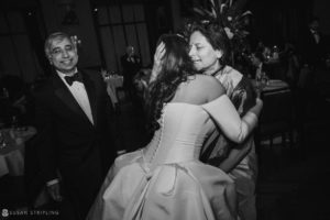 A bride and groom hugging on the dance floor at Philly's Union League wedding.