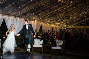 A wedding couple walking down the aisle in kilts at the Ocean Club in the Bahamas.