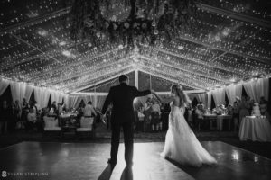 A bride and groom dancing at their oceanfront wedding reception in the Bahamas.