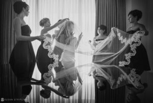 A bride and her bridesmaids are preparing their wedding veil at Vizcaya.