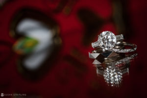 A diamond engagement ring sits on top of a red background at the Nassau Inn, perfect for a wedding.