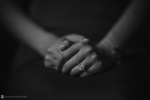 A black and white image of a woman's hands holding an engagement ring, symbolizing a special wedding moment at Nassau Inn.