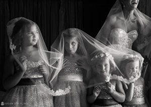 A black and white photo of a bride and her bridesmaids, captured by a WPPI Grand Master.