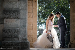 A bride and groom standing next to each other in an archway during their Vow Renewal at Vizcaya.