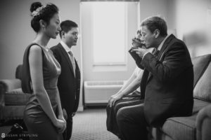 At the Nassau Inn, a man in a suit is talking to a woman in a suit at a wedding.