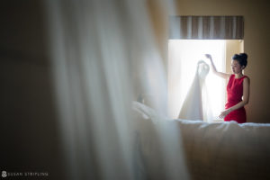 A woman in a red dress is getting ready for her wedding at the Nassau Inn.