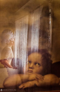 A WPPI Grand Master captured a poignant image of a woman gazing out of a window.