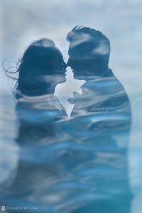 A silhouette of a couple in the water during their vow renewal at Vizcaya.