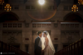 A Nassau Inn wedding ceremony featuring a bride and groom standing on the steps of a church.