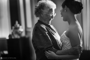 A black and white photo of a bride hugging her WPPI Grand Master grandmother.