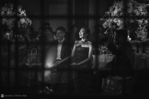 A bride and groom sitting at a table in a black and white photo at their Nassau Inn wedding.