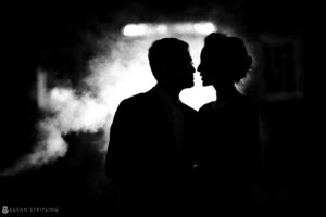 A silhouette of a couple kissing at their wedding in the dark at Nassau Inn.