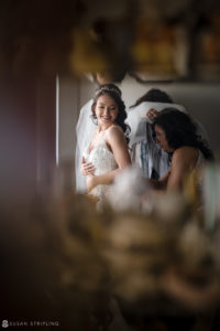 A bride preparing for her wedding in front of a mirror at Florentine Gardens estate.