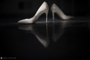 A pair of high heeled wedding shoes on a table at Florentine Gardens estate.