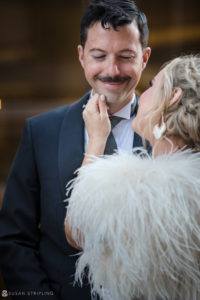 A wedding couple wearing their elegant hats at Loews Hotel Philly.