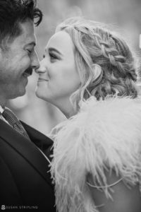 A black and white photo of a wedding couple sharing a kiss at Loews Hotel Philly.