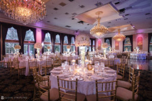 A wedding reception at Florentine Gardens, an estate with a large ballroom adorned with chandeliers.