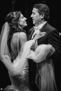 A black and white photo of a bride and groom captured at the picturesque Florentine Gardens estate during their wedding.