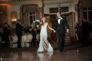 A wedding couple walking down the aisle at their Pleasantdale Chateau reception.