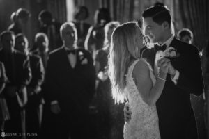 At the exquisite Pleasantdale Chateau, a bride and groom captivate guests with their first dance, beautifully captured in a black and white wedding photo.