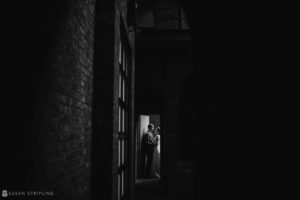A newlywed couple celebrating their wedding in a charming alleyway.