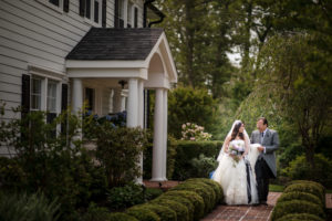 A bride and groom standing in front of a St. Regis.