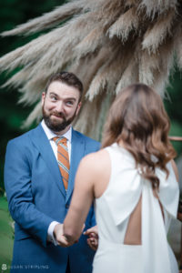 A bride and groom exchange loving glances at their Stonover Farm wedding ceremony.