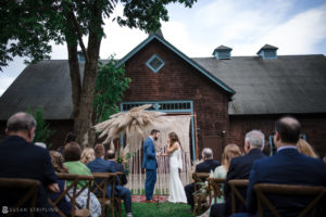 A Stonover Farm wedding ceremony in front of a barn.
