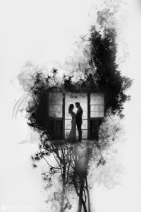 A black and white wedding photo of a couple standing in front of a window at Stonover Farm.