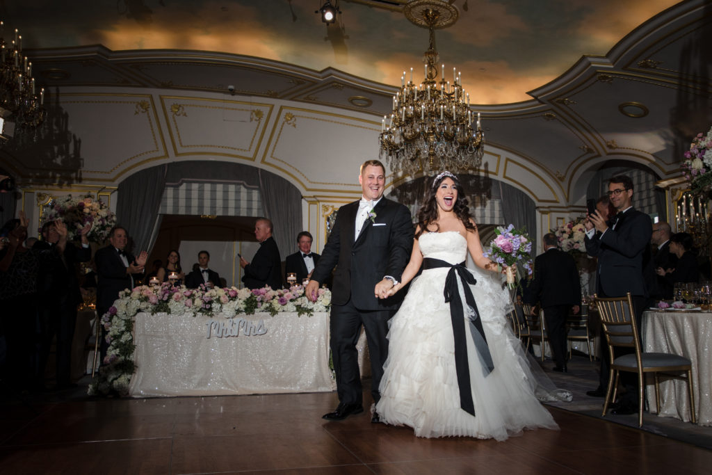 A bride and groom walking down the aisle at their St. Regis wedding.