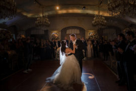 The bride and groom have their first dance at their elegant wedding held in a romantic ballroom at the luxurious St. Regis hotel.
