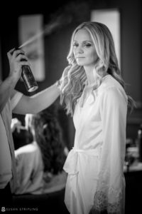 A bride getting her hair done in a black and white photo at a Wedding venue in New York.