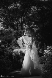 A wedding bride wearing a veil in the New York Botanical Gardens.