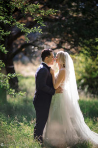 Newlywed couple kissing at their romantic New York Botanical Gardens wedding.