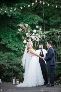 A New York bride and groom exchange vows in the serene beauty of a botanical garden.